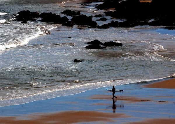 A surfer at Coldingham Bay. Picture: Sean Bell