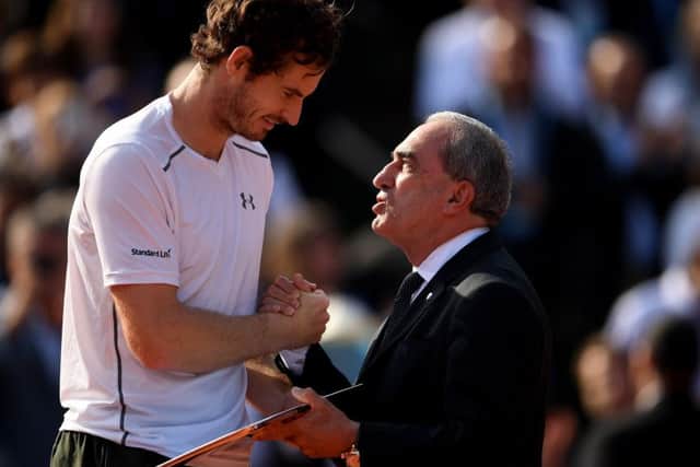 Andy Murray receives the runners-up trophy from Jean Gachassin the ITF President following his Men's Singles final against Novak Djokovic at the French Open. Picture: Dennis Grombkowski/Getty