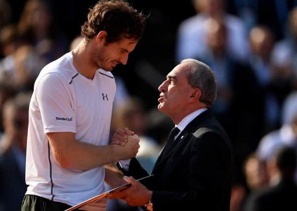 Andy Murray receives the runners-up trophy from Jean Gachassin the ITF President following his Men's Singles final against Novak Djokovic at the French Open. Picture: Dennis Grombkowski/Getty