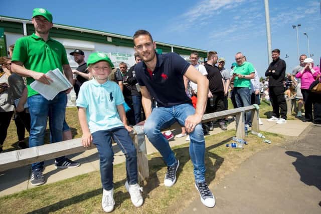 Celtic goalkeeper Craig Gordon with fan Ava Keenan, 6, who was in line with her family to buy season tickets. Picture: SNS