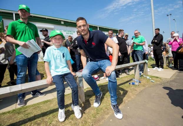 Celtic goalkeeper Craig Gordon with fan Ava Keenan, 6, who was in line with her family to buy season tickets. Picture: SNS