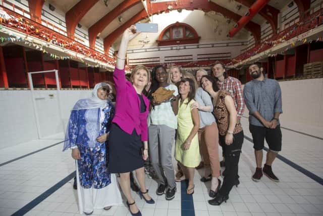 Nicola Sturgeon meets members of the Govanhill Baths Community Trust in the empty main pool, which has been used as a performance space. Picture: Jeff Holmes