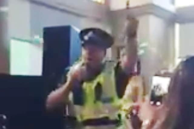 Sergeant Jon Harris singing Gloria Gaynor's I Will Survive while in full uniform to cheers from drinkers at Glasgow's Waterloo Bar. Picture: PA