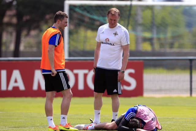 Northern Ireland manager Michael O'Neill checks on the injured Kyle Lafferty. Picture: Jonathan Brady/PA Wire