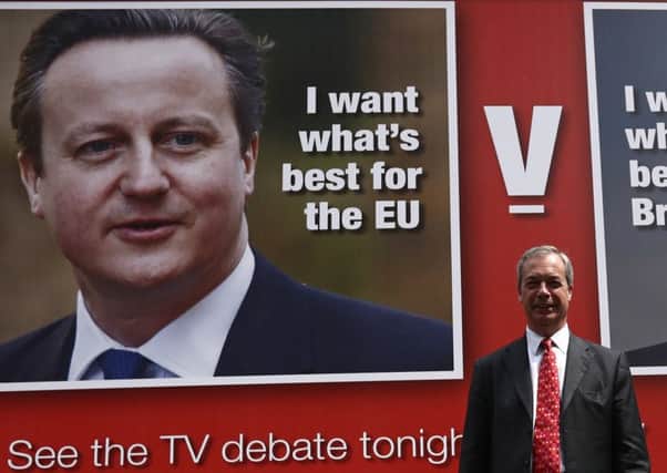 Nigel Farage unveils a new campaign poster ahead of his televised debate with David Cameron. Picture: Getty Images