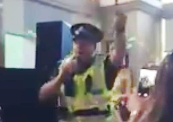 Sgt Jon Harris singing I Will Survive while in full uniform to cheers from drinkers at Glasgow's Waterloo Bar. Picture: PA