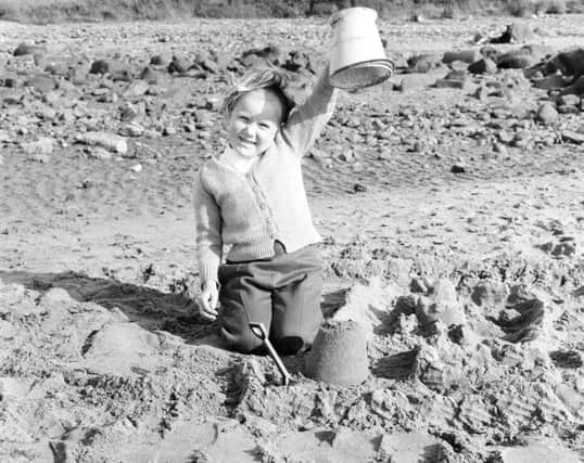 A girl shows off her sandcastle on Portobello beach in July 1965. Picture: TSPL