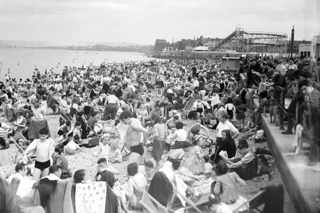 Portobello beach was crowded on May 25, 1952, as thousands of people enjoyed the warm weather. The fun fair can be seen in the distance. Picture: TSPL