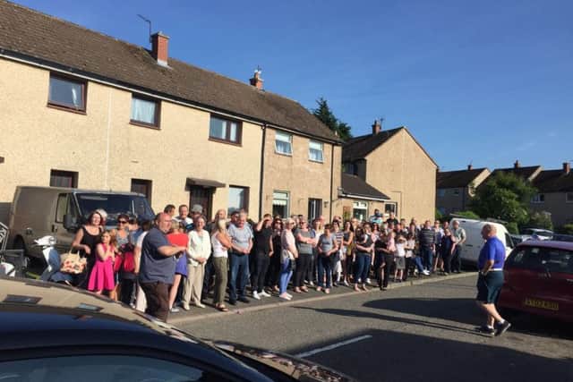 Locals in Pathhead gather outside the home where convicted rapist Robert Greens is expected of being moved to. Picture: Pamela Hunter