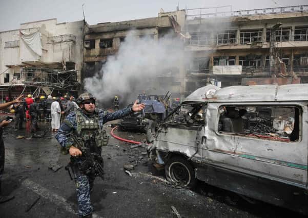 Iraqi security forces and rescue workers at the site of car bomb attack in the mostly Shiite neighbourhood of Baghdad Jadida. Picture: Getty Images
