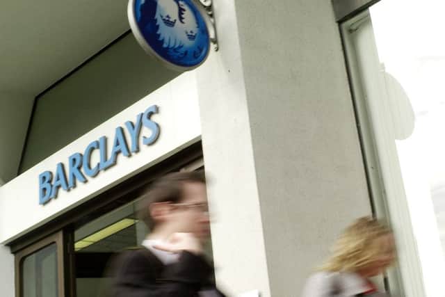 People walk pass a branch of Barclays Bank. (AP Photo/Sang Tan)