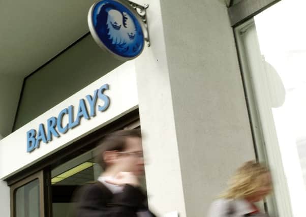 People walk pass a branch of Barclays Bank. (AP Photo/Sang Tan)