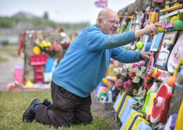 Charley Whyte, 76, inspects his mural on a wall in Lossiemouth, Moray. Picture: SWNS