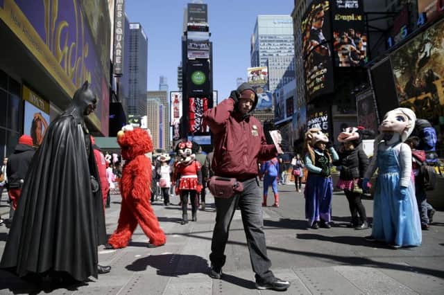 Costumed performers in Times  Square are to be confined to activity zones. Picture: AP
