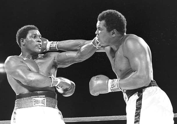 Trevor Berbick, left, and Muhammad Ali trade blows in Nassau during what turned out to be Ali's last bout. Picture: AP