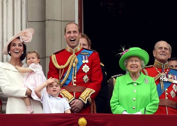 The Queen joins members of the royal family, including the Duke and Duchess of Cambridge with their children Princess Charlotte and Prince George, on the balcony of Buckingham Palace. Picture: Steve Parsons/PA Wire