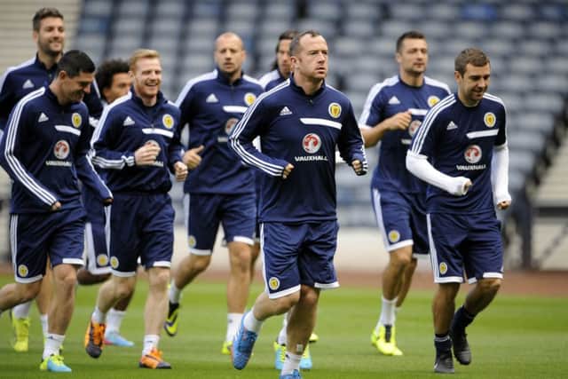 Charlie Adam leads Scotland training in 2013. Picture: Greg Macvean