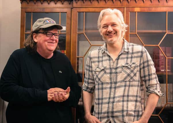 Film-maker Michael Moore meets WikiLeaks founder Julian Assange inside the Ecuadorian embassy in London. Picture: PA