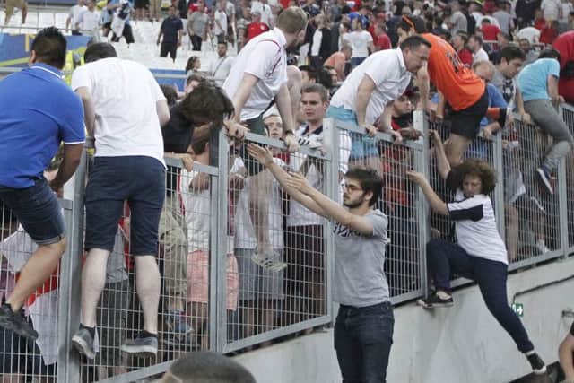 The scenes in the Stade Velodrome on Saturday were reminiscent of the dark days of hooliganism as English fans clamboured to find safety when a horde of Russian fans attacked them. Picture: AP
