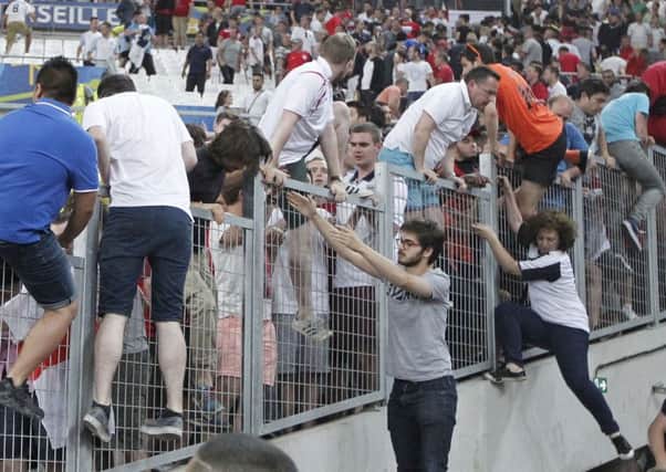 The scenes in the Stade Velodrome on Saturday were reminiscent of the dark days of hooliganism as English fans clamboured to find safety when a horde of Russian fans attacked them. Picture: AP