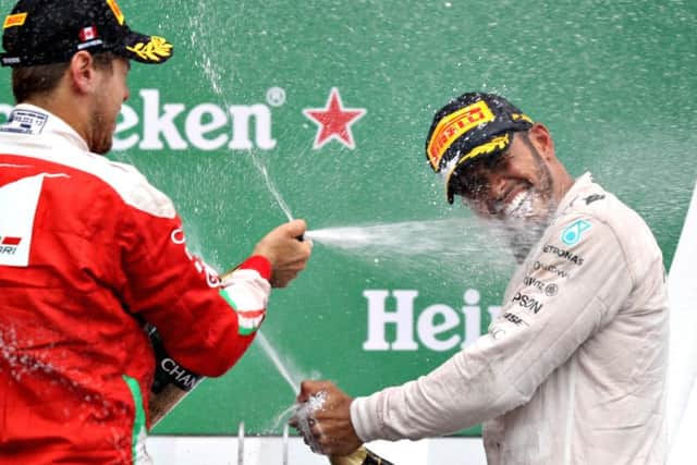 Canadian Grand Prix winner Lewis Hamilton is sprayed with champagne by Sebastian Vettel. Picture: Getty Images