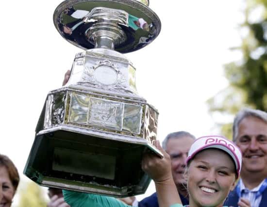 Brooke Henderson holds aloft the tropht after her play-off win over Lydia Ko. Picture: AP