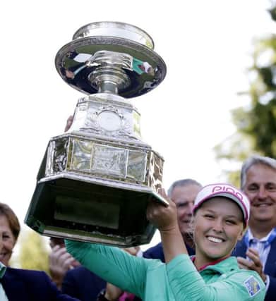 Brooke Henderson holds aloft the tropht after her play-off win over Lydia Ko. Picture: AP