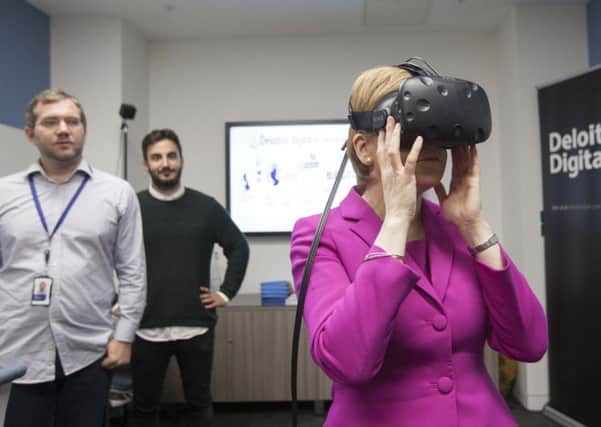 Nicola Sturgeon tries out some new technology as she opens Deloittes new office in Glasgow.

Picture: Chris James
