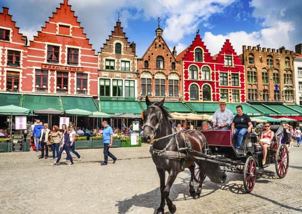 Horse carriage with tourists on Grote Markt square