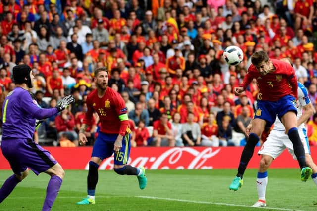 Defender Gerard Pique  heads home in the the 87th minute to give Spain a winning start to their Euro campaign. Picture: Philippe Marcou/AFP