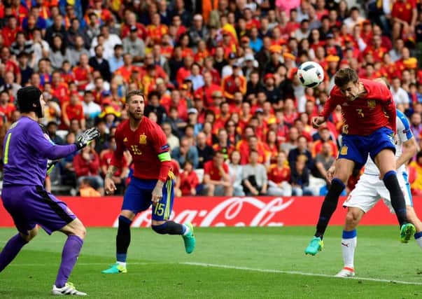 Defender Gerard Pique  heads home in the the 87th minute to give Spain a winning start to their Euro campaign. Picture: Philippe Marcou/AFP
