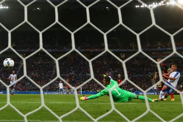 Belgium goalkeeper Thibaut Courtois can do nothing to stop Emanuele Giaccherinis shot hitting the  back on the net to give Italy a one-goal lead after 32 minutes in Lyon. Picture: Michael Steele/Getty