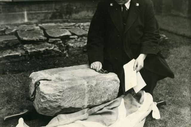 James Wishart, custodian of Arbroath Abbey, inspects the stone after it was recovered in April 1951