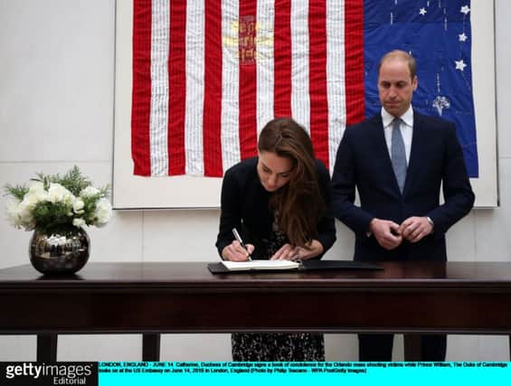 Catherine, Duchess of Cambridge signs a book of condolence for the Orlando mass shooting victims while Prince WIlliam, The Duke of Cambridge looks on at the US Embassy on June 14, 2016 in London, England. Picture: Philip Toscano/WPA Pool/Getty Images
