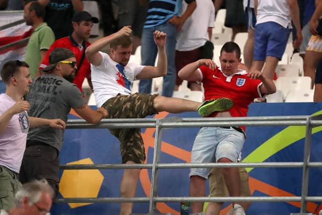 A Russian fan kicks out at an England supporter after Saturdays game between the teams at the Stade Velodrome. Picture: PA