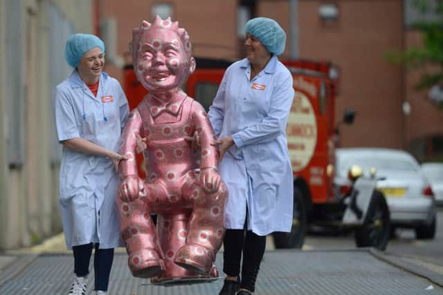 Factory workers Emma Brown, 19 and Michelle Quinn, 46,  admire a unique Oor Wullie sculpture. Picture: SWNS