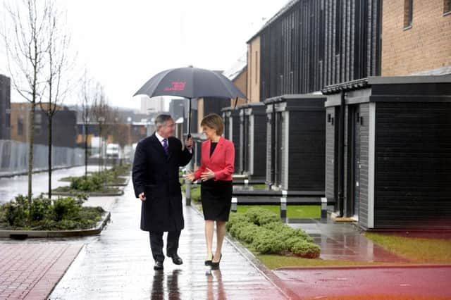Nicola Sturgeon with Gordon Mathewson at the former Commonwealth Games athletes' village. The Dalmarnock site now contains 300 private homes, 400 social rent houses and a 120-bed care home. Picture: John Devlin