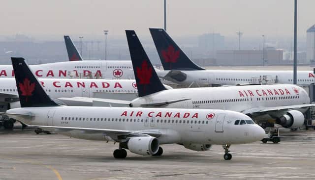 Air Canada aircraft sit on the tarmac. Picture: AP Photo/Frank Gunn