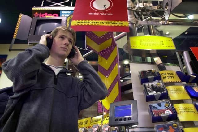 Student Chris Cartlidge listens to the latest releases at the Virgin Megastore in Princes Street, Edinburgh, in February 2000. Picture: Paul Chappells/TSPL