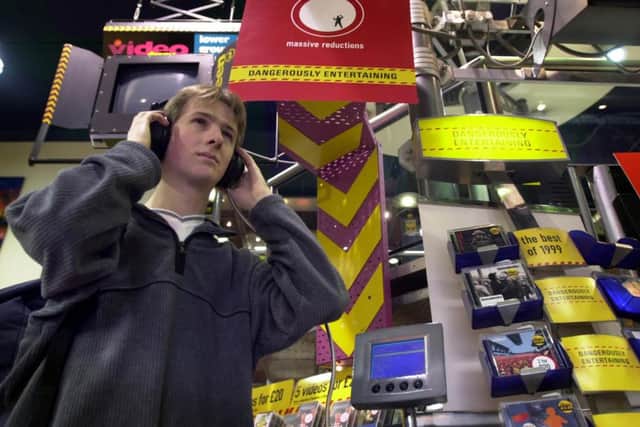 Student Chris Cartlidge listens to the latest releases at the Virgin Megastore in Princes Street, Edinburgh, in February 2000. Picture: Paul Chappells/TSPL