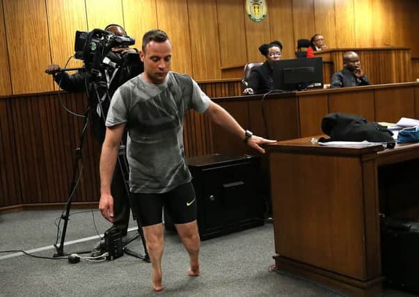 Oscar Pistorius walks without his prosthetic legs during the hearing in Pretoria, South Africa. Picture: AP