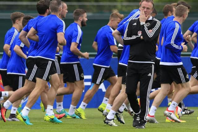 Northern Ireland manager Michael O'Neill walks in front of the players during a training session at Saint-George-de-Reneins. Picture: Jonathan Brady/PA Wire