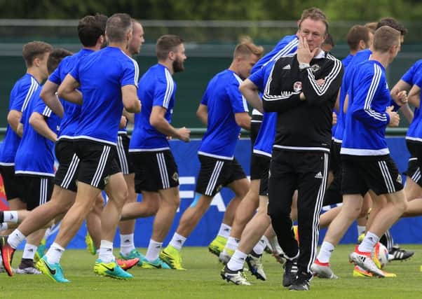 Northern Ireland manager Michael O'Neill walks in front of the  players during a training session at Saint-George-de-Reneins. Picture: Jonathan Brady/PA Wire