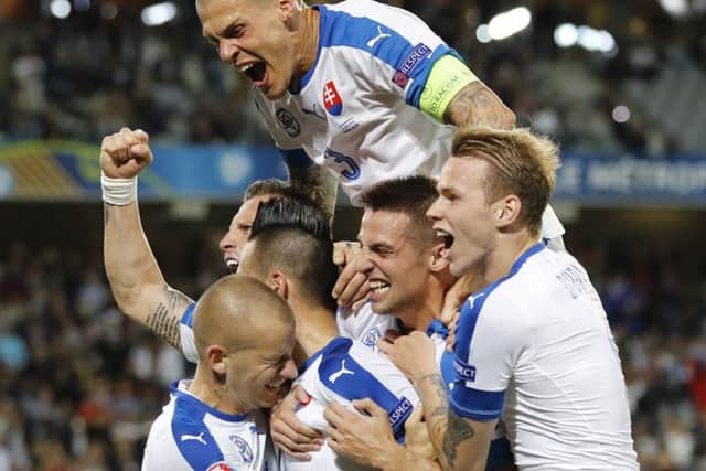 Slovakia's players celebrate after Marek Hamsik scored his side's second goal. Picture: AP