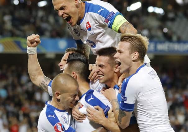 Slovakia's players celebrate after Marek Hamsik scored his side's second goal. Picture: AP