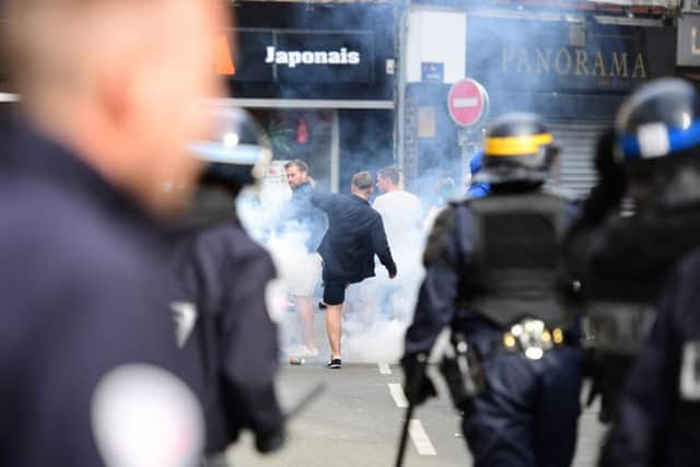 French policemen fire tear gas to disperse supporters gathering outside a bar in Lille. Picture: Leon Neal/AFP/Getty Images