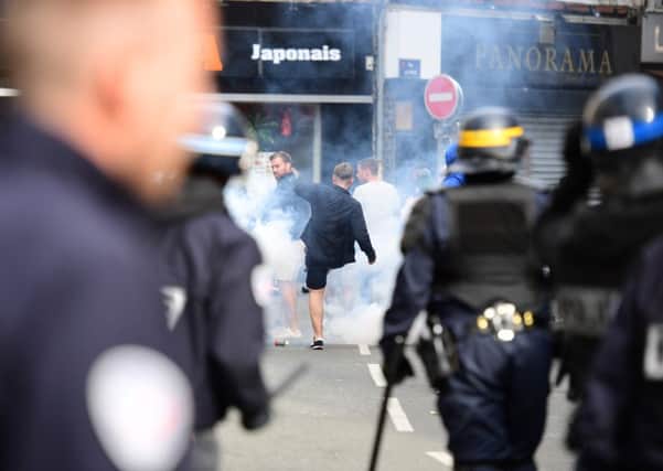 French policemen fire tear gas to disperse supporters gathering outside a bar in Lille.  Picture: Leon Neal/AFP/Getty Images