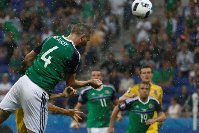 Northern Ireland defender Gareth McAuley heads the opening goal in the 2-0 win over Ukraine in Lyon. Picture: Odd Andersen/AFP/Getty Images