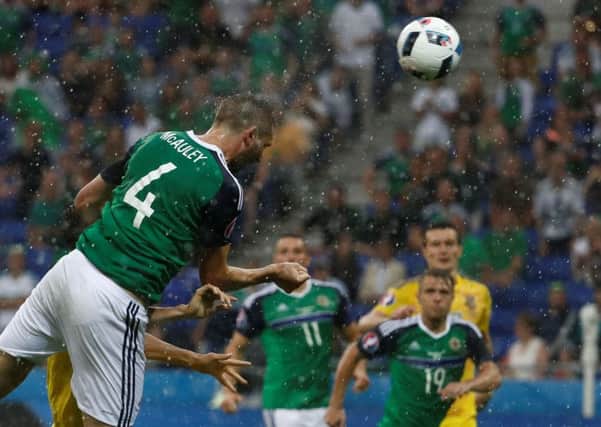 Northern Ireland defender Gareth McAuley heads the opening goal in the 2-0 win over Ukraine in Lyon. Picture: Odd Andersen/AFP/Getty Images