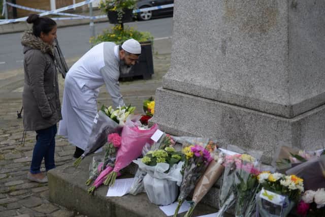 A man arrives to lay flowers in Birstall. Picture: Getty Images